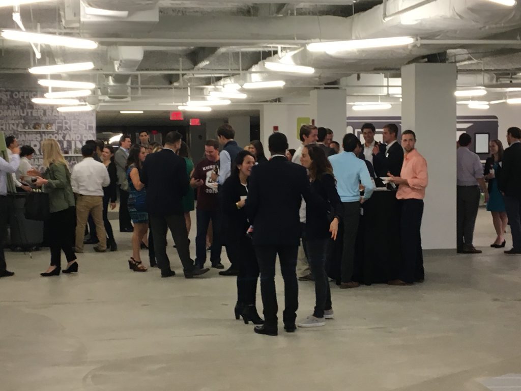 Attendees networking prior to playing cornhole.